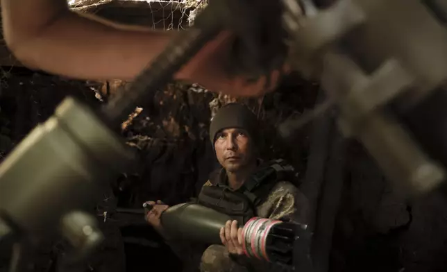 FILE - In this photo provided by Ukraine's 24th Mechanized Brigade press service, a soldier fires a 120 mm mortar toward Russian army positions near Chasiv Yar, Donetsk region, Ukraine, May 27, 2025. (Oleg Petrasiuk/Ukraine's 24th Mechanized Brigade via AP, File)