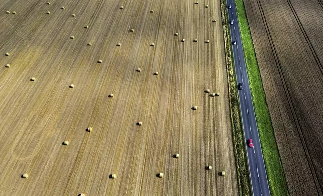 Straw bales lie on a field in the outskirts of Frankfurt, Germany, Wednesday, July 30, 2025. (AP Photo/Michael Probst)
