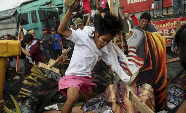 Protesters destroy an effigy of Philippine President Ferdinand Marcos Jr. in time for his State of the Nation Address in Quezon City, Philippines on Monday, July 28, 2025. (AP Photo/Basilio Sepe)
