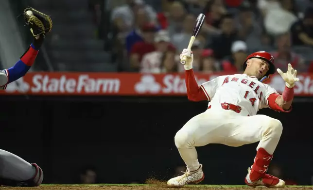 Los Angeles Angels' Logan O'Hoppe, right, reacts after a close pitch during the eighth inning of a baseball game against the Texas Rangers Monday, July 28, 2025, in Anaheim, Calif. (AP Photo/William Liang)