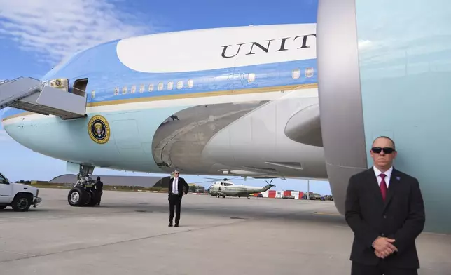 Security personnel stand by Air Force One, before President Donald Trump's arrival at Royal Air Force Lossiemouth, Tuesday, July 29, 2025, en route to return to Washington. (AP Photo/Jacquelyn Martin)