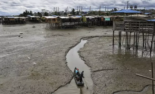 A boatman paddles through an estuary during a precautionary tsunami warning following an earthquake off the coast of Russia, in Buenaventura, on Colombia's Pacific coast, Wednesday, July 30, 2025. (AP Photo/Santiago Saldarriaga)