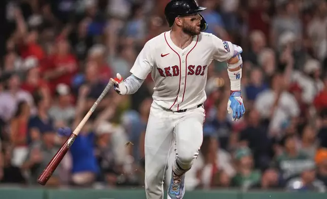 Boston Red Sox's Trevor Story watches the flight of his three-run home run during the seventh inning of a baseball game against the Colorado Rockies at Fenway Park, Tuesday, July 8, 2025, in Boston. (AP Photo/Charles Krupa)