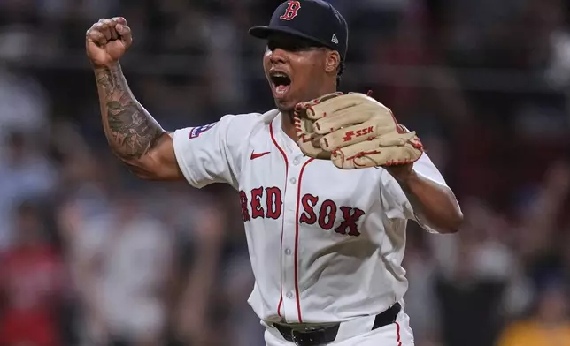 Boston Red Sox pitcher Brayan Bello celebrates after getting the win, throwing a complete game against the Colorado Rockies after a baseball game at Fenway Park, Tuesday, July 8, 2025, in Boston. (AP Photo/Charles Krupa)