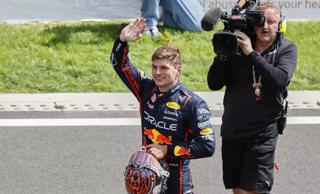 Red Bull driver Max Verstappen of the Netherlands waves after crossing the finish line to win the sprint race ahead of the Formula One Grand Prix at the Spa-Francorchamps racetrack in Spa, Belgium, Saturday, July 26, 2025. (AP Photo/Geert Vanden Wijngaert)