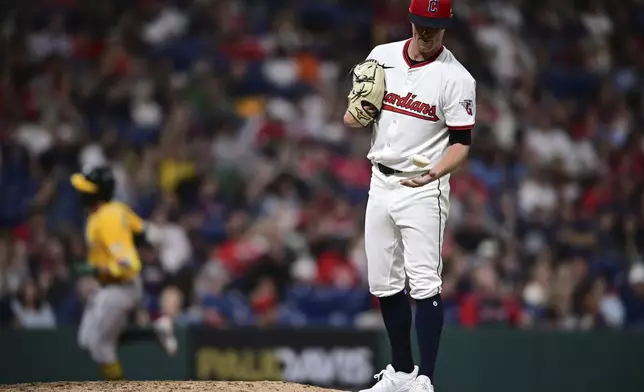 Cleveland Guardians relief pitcher Kolby Allard, right, reacts after two-run home run by Athletics' Jacob Wilson during the ninth inning of a baseball game, Saturday, July 19, 2025, in Cleveland. (AP Photo/David Dermer)