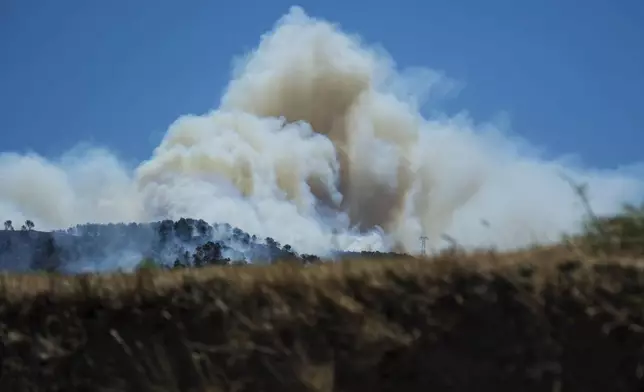 This photo provided by the fire brigade Pompiers13, shows a cloud of smoke over hills near Marseille, southern France, Tuesday, July 8, 2025. (Pompiers13 via AP)