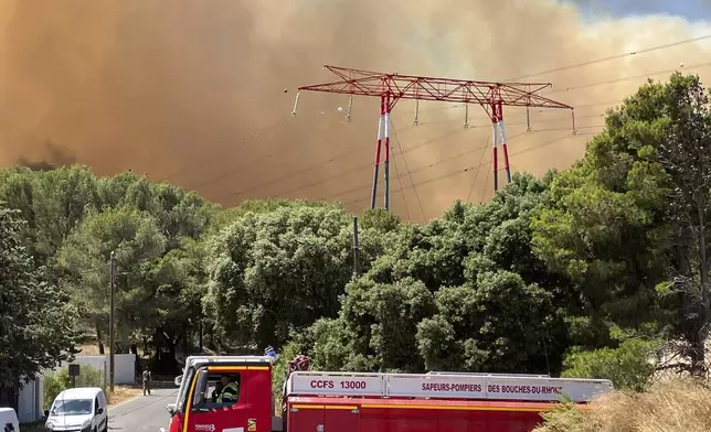 This photo provided by the fire brigade SDIS13, smoke rises during a wildfire near Marseille, southern France, Tuesday, July 8, 2025. (SDIS13 via AP)