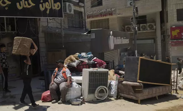 Palestinians gather their belongings ahead of homes demolition by Israeli forces in the Tulkarem refugee camp, West Bank, Wednesday, July 2, 2025. (AP Photo/Leo Correa)