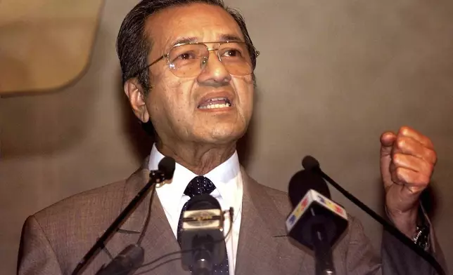 FILE - Malaysian Prime Minister Mahathir Mohamad speaks during the International Symposium on Currency Controls and Asian Monetary Cooperation in Kuala Lumpur, Sept. 2, 1999. (AP Photo/Vincent Thian)