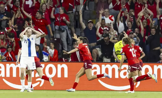 Switzerland's Riola Xhemaili, center, celebrates after scoring her side's goal during the UEFA Women's EURO 2025, group A, soccer match between Finland and Switzerland in Geneva, Switzerland, Thursday, July 10, 2025. (Salvatore Di Nolfi/Keystone via AP)
