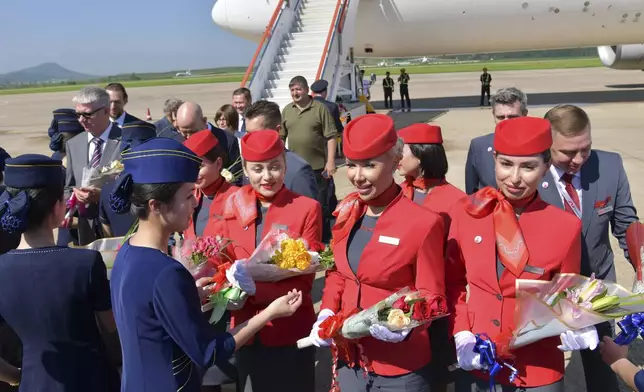 This photo provided on Tuesday, July 29, 2025, by the North Korean government, the flight attendants of the first flight operated by a Russia carrier, are greeted during a ceremony for a direct air route between Moscow and Pyongyang, at the Pyongyang International Airport in Pyongyang, North Korea, on Monday, July 28, 2025. Independent journalists were not given access to cover the event depicted in this image distributed by the North Korean government. The content of this image is as provided and cannot be independently verified. Korean language watermark on image as provided by source reads: "KCNA" which is the abbreviation for Korean Central News Agency. (Korean Central News Agency/Korea News Service via AP)