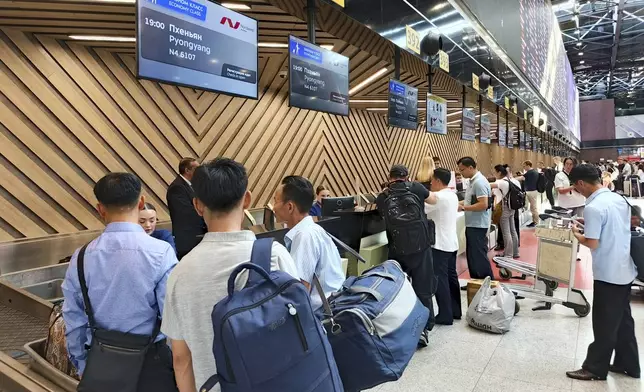 Passengers gather to check-in for the first flight connecting Moscow and Pyongyang at Moscow's Sheremetyevo International airport, amidst the warming relations between Russia and North Korea outside Moscow, Russia, Sunday, July 27, 2025. (AP Photo)