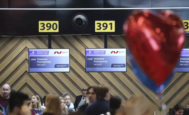 Passengers lineup to check-in for the first flight connecting Moscow and Pyongyang at Moscow's Sheremetyevo International airport amidst the warming relations between Russia and North Korea outside Moscow, Russia, Sunday, July 27, 2025. (AP Photo)