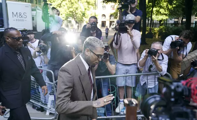 Grammy-winning singer Chris Brown makes his way into Southwark Crown Court, in London, Friday, July 11, 2025.(AP Photo/Alberto Pezzali)