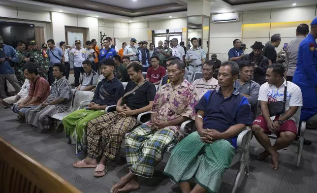 Survivors rescued after a ferry sank wait for a health examination in Gilimanuk on Bali island, Indonesia, Thursday, July 3, 2025. (AP Photo/Firdia Lisnawati)