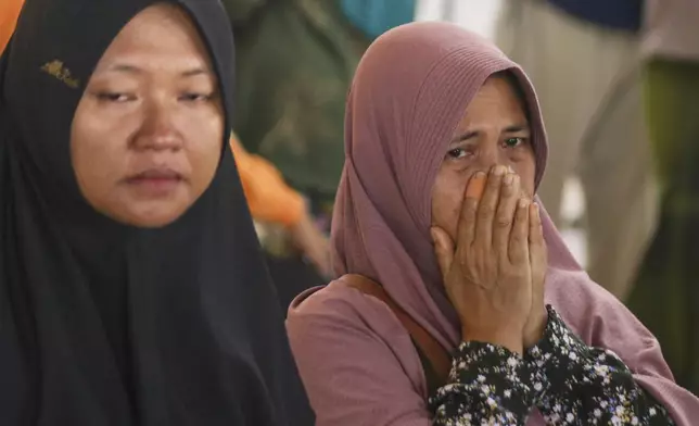 A passenger's relative weeps after a ferry carrying dozens of passengers sank near the resort island of Bali, at Ketapang Port in Bayuwangi, East Java, Indonesia, Thursday, Juli 3, 2025. (AP Photo/Andur)