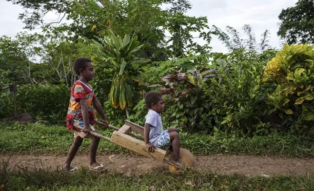 Children play on Pele Island, Vanuatu, Thursday, July 17, 2025. (AP Photo/Annika Hammerschlag)