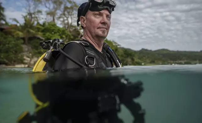 John Warmington, who has has dived the same patch of reef in Havannah Harbour, off the coast of Efate Island, Vanuatu, more than a thousand times, poses for a photo Sunday, July 20, 2025. (AP Photo/Annika Hammerschlag)