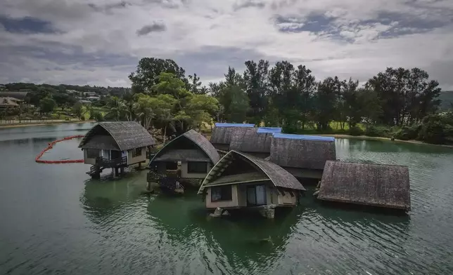 The once iconic Holiday Inn villas in Port Vila, Vanuatu, Saturday, July 19, 2025, sit partially sunken after being hit by multiple cyclones and an earthquake that caused irreparable damage. (AP Photo/Annika Hammerschlag)