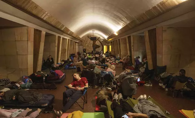 People sleep on the platform of a metro station as they take cover during a Russian attack on Kyiv, Ukraine, on Thursday, July 10, 2025. (AP Photo/Evgeniy Maloletka)