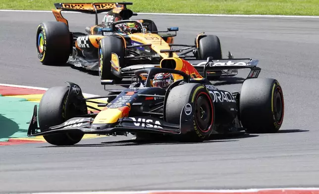 Red Bull driver Max Verstappen of the Netherlands, right, steers his car ahead of McLaren driver Oscar Piastri of Australia during the sprint race ahead of the Formula One Grand Prix at the Spa-Francorchamps racetrack in Spa, Belgium, Saturday, July 26, 2025. (AP Photo/Geert Vanden Wijngaert)