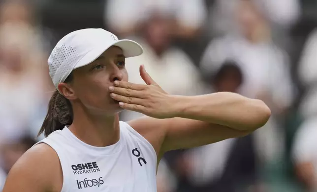 Iga Swiatek of Poland celebrates after beating Danielle Collins of the U.S. during a third round women's singles match at the Wimbledon Tennis Championships in London, Saturday, July 5, 2025. (AP Photo/Kirsty Wigglesworth)