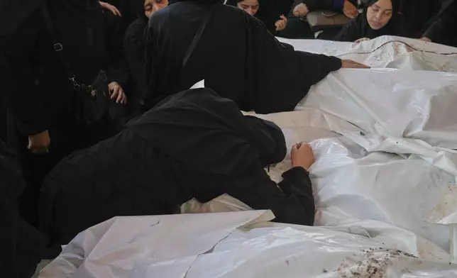 Mourners attend the funeral of their relatives who were killed in an Israeli bombardment, in Deir al-Balah, Gaza Strip, Saturday, July 12, 2025. (AP Photo/Abdel Kareem Hana)
