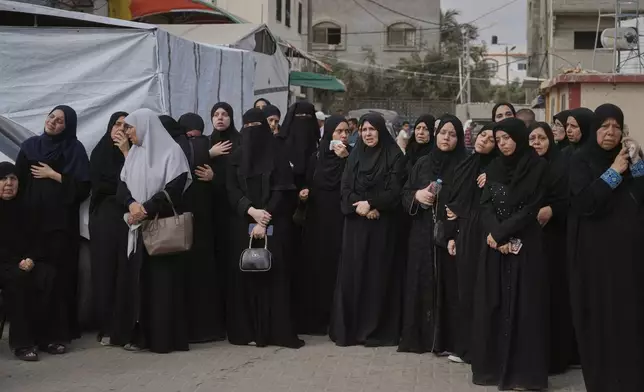 Mourners attend the funeral of their relatives who were killed in an Israeli bombardment, in Deir al-Balah, Gaza Strip, Saturday, July 12, 2025. (AP Photo/Abdel Kareem Hana)