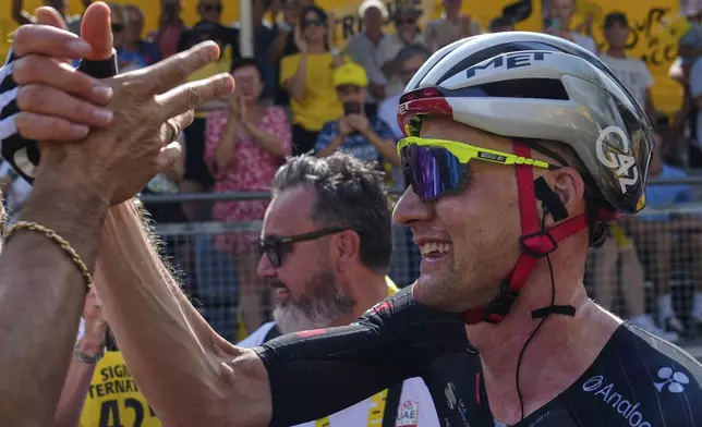 Stage winner Belgium's Tim Wellens celebrates after crossing the finish line of the fifteenth stage of the Tour de France cycling race over 169.3 kilometers (105.2 miles) with start in Muret and finish in Carcassonne, France, Sunday, July 20, 2025. (AP Photo/Mosa'ab Elshamy, POOL)