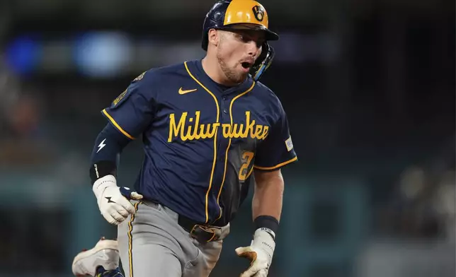 Milwaukee Brewers' Caleb Durbin celebrates as he rounds third after hitting a solo home run during the seventh inning of a baseball game against the Los Angeles Dodgers, Friday, July 18, 2025, in Los Angeles. (AP Photo/Mark J. Terrill)