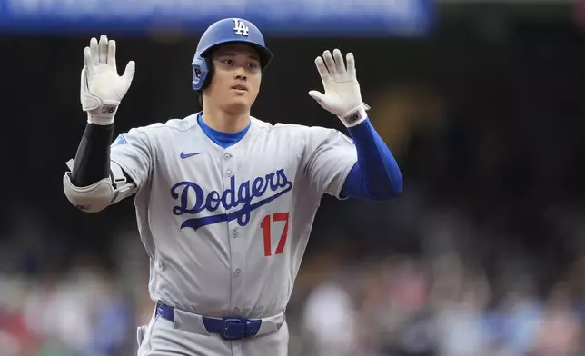 Los Angeles Dodgers' Shohei Ohtani gestures as he rounds the bases after hitting a solo home run during the first inning of a baseball game against the Milwaukee Brewers, Tuesday, July 8, 2025, in Milwaukee. (AP Photo/Aaron Gash)
