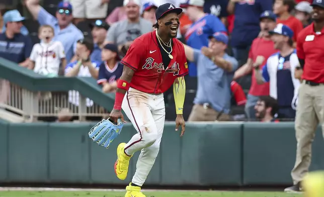 Atlanta Braves outfielder Ronald Acuña Jr. reacts after throwing out a runner at third base in the third inning of a baseball game against the New York Yankees, Friday, July 18, 2025, in Atlanta. (AP Photo/Colin Hubbard)