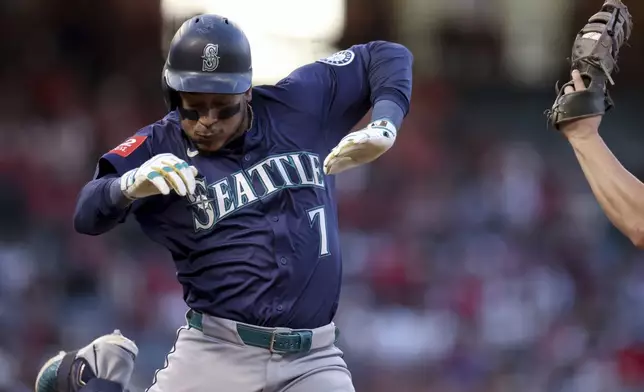 Seattle Mariners designated hitter Jorge Polanco (7) is tagged out at first base by Los Angeles Angels first baseman Nolan Schanuel during the fourth inning of a baseball game Friday, July 25, 2025, in Anaheim, Calif. (AP Photo/Eric Thayer)