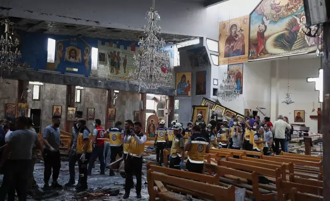 Syrians gather inside Mar Elias church where a suicide bomber detonated himself in Dweil'a in the outskirts of Damascus, Syria, June 22, 2025. (AP Photo/Omar Sanadiki)