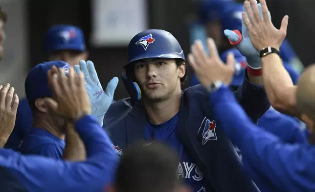 Toronto Blue Jays' Joey Loperfido celebrates with teammates in the dugout after hitting a solo home run during the fifth inning of a baseball game against the Chicago White Sox, Monday, July 7, 2025, in Chicago. (AP Photo/Paul Beaty)