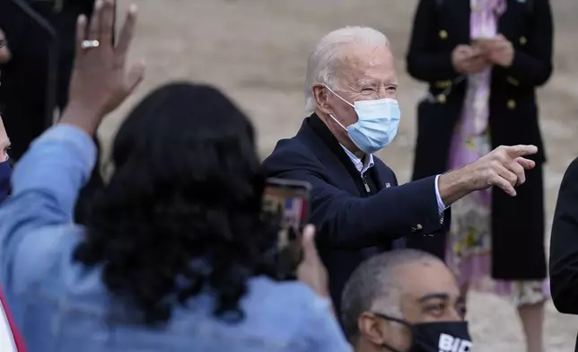 FILE - President-elect Joe Biden greet supporters after speaking at a drive-in rally for Georgia Democratic candidates, Dec. 15, 2020, in Atlanta. (AP Photo/Patrick Semansky, File)