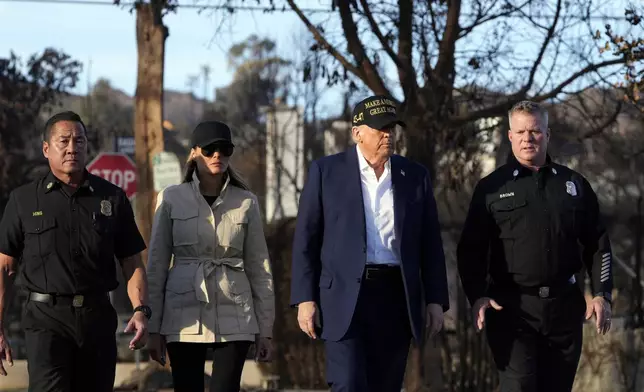 President Donald Trump, center right, and first lady Melania Trump walk, center left, walk with Jason Hing, chief deputy of emergency services at the Los Angles Fire Department, left, and Capt. Jeff Brown, Chief of Station 69, as they tour the Pacific Palisades neighborhood affected by recent wildfires in Los Angeles, Jan. 24, 2025. (AP Photo/Mark Schiefelbein, File)