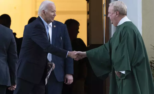 FILE - President Joe Biden, left, is greeted by a priest as he leaves St. Joseph on the Brandywine Catholic Church in Wilmington, Del., after attending a mass, Nov. 2, 2024. (AP Photo/Manuel Balce Ceneta, File)