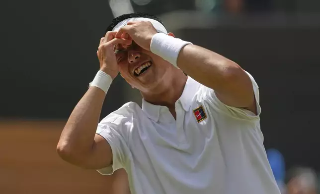Tokito Oda of Japan celebrates winning the men's wheelchair singles final match against and Alfie Hewett of Britain at the Wimbledon Tennis Championships in London, Sunday, July 13, 2025.(AP Photo/Joanna Chan)