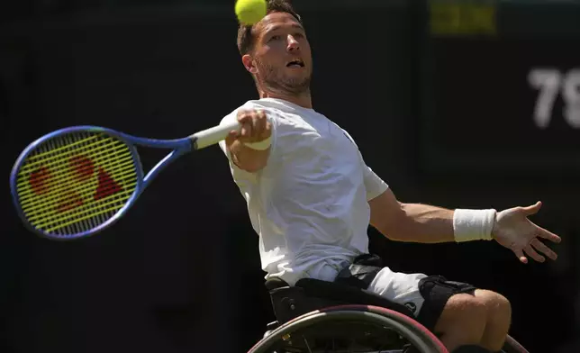 Alfie Hewett of Britain returns to Tokito Oda of Japan during the men's wheelchair singles final match at the Wimbledon Tennis Championships in London, Sunday, July 13, 2025.(AP Photo/Joanna Chan)