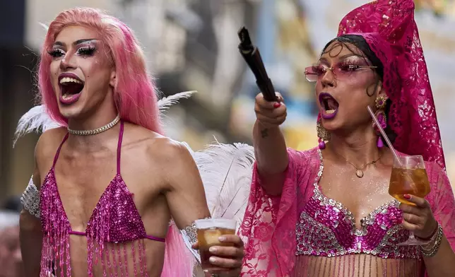 People in drag take part in festivities and preparations ahead of the annual high heel race during Madrid's Pride week in Madrid, Thursday, July 3, 2025. (AP Photo/Manu Fernandez)