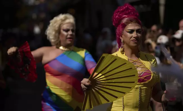 People take part in festivities and preparations ahead of the annual high heel race during Madrid's Pride week in Madrid, Spain, Thursday, July 3, 2025. (AP Photo/Manu Fernandez)