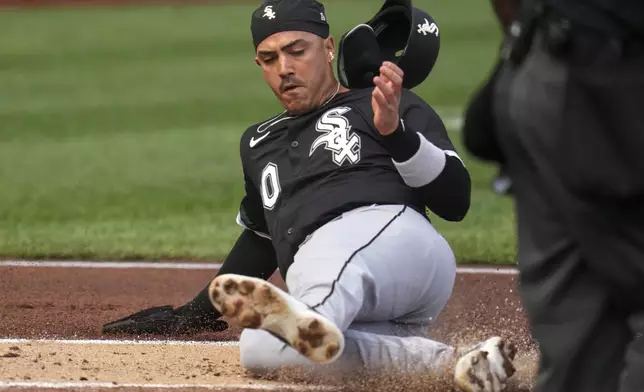 Chicago White Sox's Miguel Vargas scores on a double by Andrew Benintendi off Pittsburgh Pirates pitcher Bailey Falter during the first inning of a baseball game in Pittsburgh, Friday, July 18, 2025. (AP Photo/Gene J. Puskar)