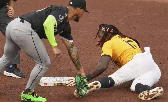 Pittsburgh Pirates' Oneil Cruz, right, slides safely into second with a stolen base as Chicago White Sox second base Lenyn Sosa applies the late tag during the fourth inning of a baseball game in Pittsburgh, Friday, July 18, 2025. (AP Photo/Gene J. Puskar)