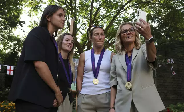 England's coach Sarina Wiegman takes a selfie during a special reception, to celebrate their victory in the Women's Euro 2025 final, at Downing Street in London, Monday, July 28, 2025. (Richard Pohle/Pool Photo via AP)