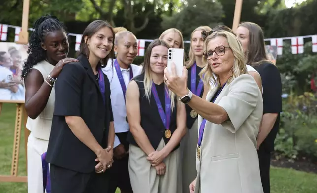 England's coach Sarina Wiegman, right, takes part in a video call with Britain's Prime Minister Sir Keir Starmer as they attend a special reception, to celebrate their victory in the Women's Euro 2025 final, at Downing Street in London, Monday, July 28, 2025. (Richard Pohle/Pool Photo via AP)