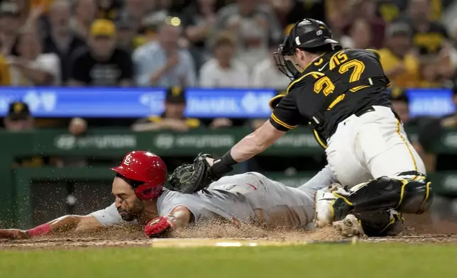 Pittsburgh Pirates catcher Henry Davis, right, tags out St. Louis Cardinals' Jose Fermin, left, at home during the ninth inning of a baseball game, Tuesday, July 1, 2025, in Pittsburgh. (AP Photo/Matt Freed)
