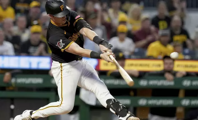 Pittsburgh Pirates' Henry Davis hits a sacrifice fly during the eighth inning of a baseball game against the St. Louis Cardinals, Tuesday, July 1, 2025, in Pittsburgh. (AP Photo/Matt Freed)