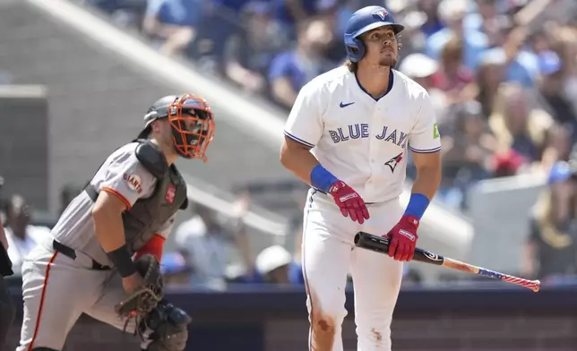 Toronto Blue Jays' Addison Barger watches as he hits a two-run home run during the fifth inning of a baseball game against the San Francisco Giants in Toronto, Sunday, July 20, 2025. (Nathan Denette/The Canadian Press via AP)